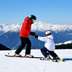 Beginner Skiing Lesson**

A professional ski instructor, fully clothed in appropriate winter gear, demonstrating the "plow" technique to a student on a gentle slope. The student is also fully clothed in a warm ski suit. The background shows a snowy mountain landscape with a clear sky. Safe for work, appropriate content, modest attire, professional instruction, perfect anatomy, natural proportions, family-friendly.

**